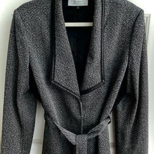 This is a Tahari jacket in a tweed fabric which is polyester and rayon.
